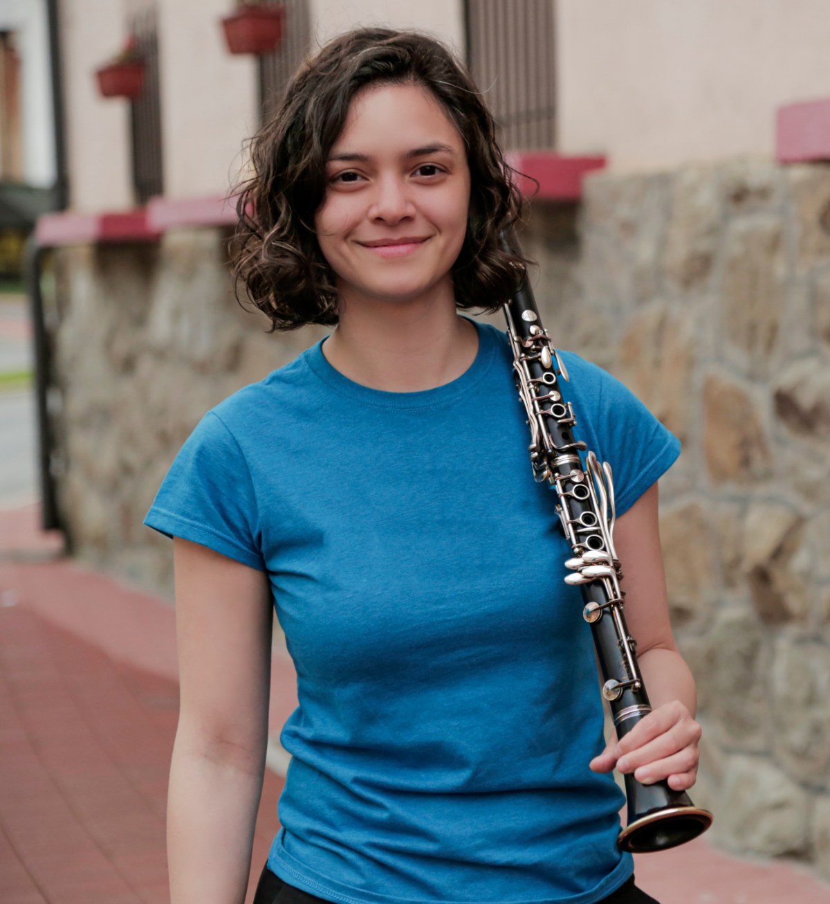 Gabrielle Molina, musician and music education leader, holding her clarinet